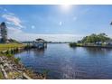 Relaxing view of a canal with a dock and boats at 821 White Heron Blvd, Ruskin, FL 33570