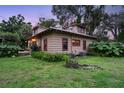 House's back with a deck and lush landscaping at 117 Tucker Ave, Sarasota, FL 34232