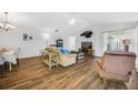 Spacious living room with wood-look tile flooring, ceiling fan, and ample natural light at 1442 Tiverton Dr, Brandon, FL 33511