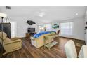 Inviting living room features wood-look tile, neutral walls, and bright windows at 1442 Tiverton Dr, Brandon, FL 33511