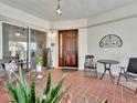 Inviting condo entryway with tiled flooring and patio furniture at 1022 Bellasol Way # 5302, Apollo Beach, FL 33572