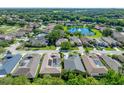 Aerial view of house for sale in a lakefront community at 12215 Woodlands Cir, Dade City, FL 33525