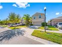 Two-story house on a tree-lined street with driveway and cars parked at 17035 Peaceful Valley Dr, Wimauma, FL 33598