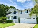 Two-story home with gray siding, white trim, and a two-car garage at 5002 W Homer Ave, Tampa, FL 33629