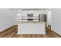 Modern kitchen with granite countertops and island at 5461 Kempson Ln, Port Charlotte, FL 33981