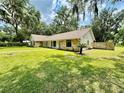 House exterior showcasing stone accents and a lush lawn at 1501 Buell Ct, Plant City, FL 33567