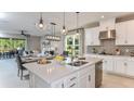 Spacious kitchen with island, white cabinets, and stainless steel appliances at 10575 Piedra Dr, Palmetto, FL 34221