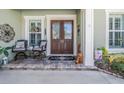 Front porch with double doors and seating area at 19340 Autumn Chase Ct, Land O Lakes, FL 34638