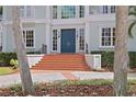 Charming front entrance with brick steps and a pair of stylish blue double doors at 814 S Bayside Dr, Tampa, FL 33609