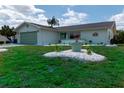 Single story home with light green garage door and nicely landscaped lawn at 1508 Fort Duquesna Dr, Sun City Center, FL 33573