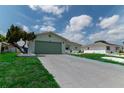 Single story home with light green garage door and nicely landscaped lawn at 1508 Fort Duquesna Dr, Sun City Center, FL 33573
