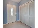 Entryway with white door and built-in storage at 2005 El Rancho Dr, Sun City Center, FL 33573