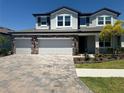 Two-story house with a three-car garage and nicely landscaped yard at 12964 Willow Grove Dr, Riverview, FL 33579