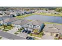 Aerial view of a house and neighborhood with a lake at 12964 Willow Grove Dr, Riverview, FL 33579