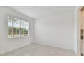 Spacious dining room with large window and neutral color palette at 4939 Eagle Rock Dr, Wimauma, FL 33598