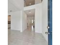 Bright and airy entryway with tile flooring and open staircase at 4939 Eagle Rock Dr, Wimauma, FL 33598