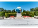 Landscaped entrance with a large globe feature at 2280 World Parkway Blvd # 20, Clearwater, FL 33763