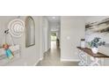 Bright entryway with tile flooring leads into the home, decorated with beachy decor and neutral tones at 814 Flash Dr, Clearwater, FL 33765
