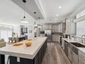 Modern kitchen with large island, stainless steel appliances, and light cabinets at 338 Stevensville St, Port Charlotte, FL 33954