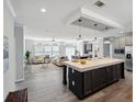 Open kitchen with large island, stainless steel appliances, and light cabinets at 338 Stevensville St, Port Charlotte, FL 33954