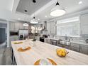 Modern kitchen with large island, stainless steel appliances, and light cabinets at 338 Stevensville St, Port Charlotte, FL 33954