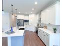 Modern kitchen with island, stainless steel appliances, and white cabinets at 17399 Masten Ave, Port Charlotte, FL 33954