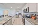 Modern kitchen with stainless steel appliances and granite countertops at 17039 Oval Rum Dr, Wimauma, FL 33598