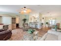 Open living area with seating, dining, and kitchen at 37607 Neukom Ave, Zephyrhills, FL 33541