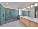 Modern bathroom with a walk-in shower featuring decorative tile and dual sink vanity at 1007 Emerald Dunes Dr, Sun City Center, FL 33573