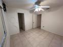 Empty bedroom with tile floor and ceiling fan at 22491 Delhi Ave, Port Charlotte, FL 33952