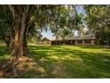 Ranch-style home nestled under large oak trees at 4805 Bugg Rd, Plant City, FL 33567