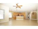 Open kitchen with light wood cabinets, granite countertops, and stainless steel appliances at 4922 Sandy Brook Cir, Wimauma, FL 33598
