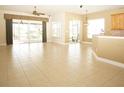 Bright and airy living room with tile flooring and sliding glass doors at 4922 Sandy Brook Cir, Wimauma, FL 33598