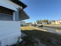 Beautiful waterfront property with a canal view, boat dock, and lush green grass at 116 W Saint Johns Way, Apollo Beach, FL 33572