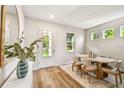 Entryway featuring a white door, light wood floors, and contemporary decor creates a welcoming and bright arrival at 7201 S De Soto St, Tampa, FL 33616