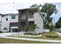 Striking two-story home with a modern design and beautifully landscaped front yard at 7201 S De Soto St, Tampa, FL 33616