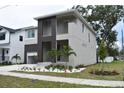 Striking two-story home with a modern design and beautifully landscaped front yard at 7201 S De Soto St, Tampa, FL 33616