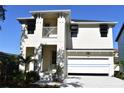 Charming two-story home featuring a clean white exterior and an attached two-car garage at 7205 S De Soto St, Tampa, FL 33616