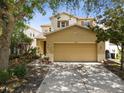 Two-story house exterior with a two-car garage and landscaping at 17539 Balmaha Dr, Land O Lakes, FL 34638
