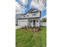 Two-story modern farmhouse style home with dark metal roof at 7203 S De Soto St, Tampa, FL 33616