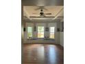 Spacious living room with bay windows, hardwood floors, and ceiling fan at 3008 N Nebraska Ave, Tampa, FL 33603