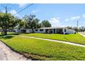 Front view of a remodeled house on a tree-lined street at 3916 W Wisconsin Ave, Tampa, FL 33616