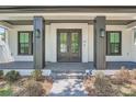 Front entrance with double doors, gray columns, and brick walkway at 325 33Rd N Ave, St Petersburg, FL 33704