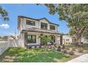 Two-story house, white siding, gray accents, landscaping, and walkway at 325 33Rd N Ave, St Petersburg, FL 33704