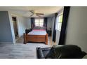 Bedroom with a double bed and floor-length window curtains at 3506 Hoover Dr, Holiday, FL 34691