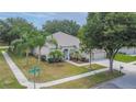 Inviting single-Gathering home with lush landscaping, a manicured lawn, and ample parking at 12902 Cattail Shore Ln, Riverview, FL 33579