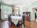 Elegant dining room with hardwood floors, chandelier, and ample natural light at 28330 Openfield Loop, Wesley Chapel, FL 33543