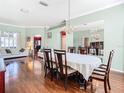 Elegant dining room with hardwood floors, chandelier, and ample seating for formal gatherings at 28330 Openfield Loop, Wesley Chapel, FL 33543