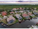 Aerial view showcasing waterfront homes, private docks, and lush greenery near the open bay at 5510 E Longboat Blvd, Tampa, FL 33615