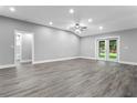 Spacious, bright living area features hardwood floors, recessed lighting, and double glass doors at 11734 Orange Ct, Dade City, FL 33525